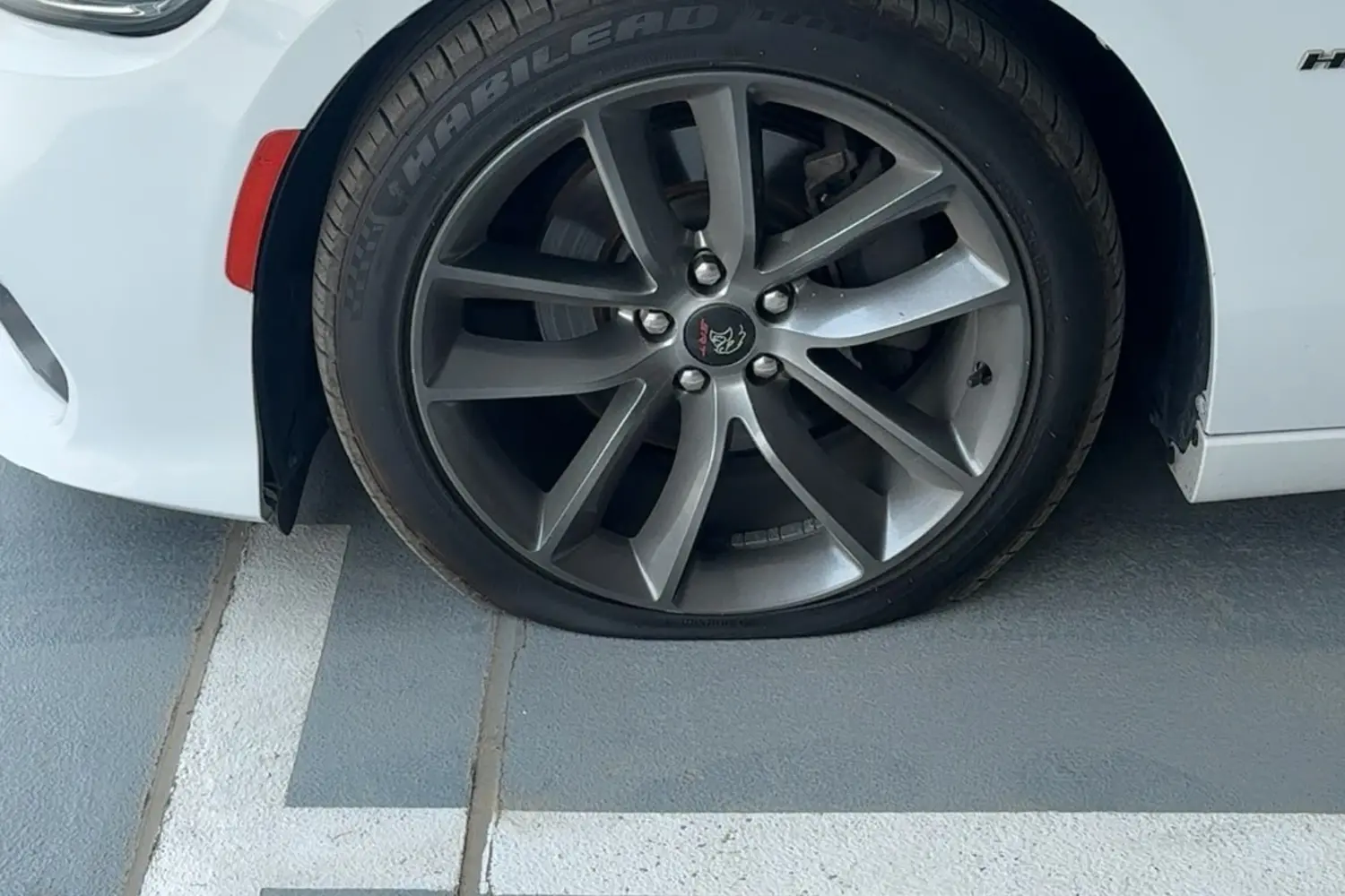 Flat vehicle tyre ready for mobile roadside assistance